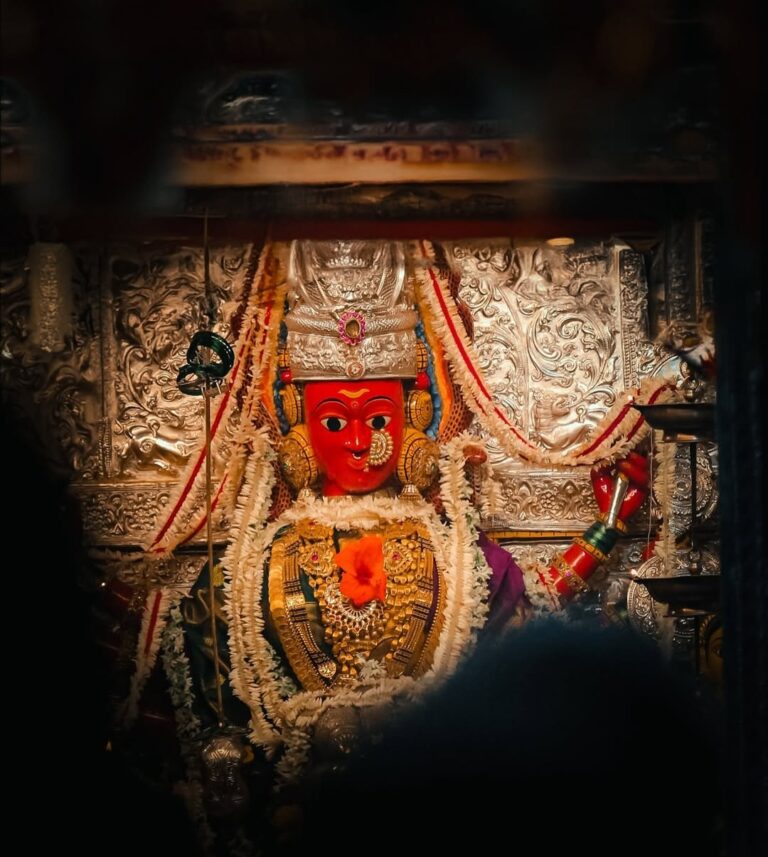 Sacred image of Goddess Marikamba at Sirsi temple, worshipped in a vibrant setting with oil lamps and floral decorations