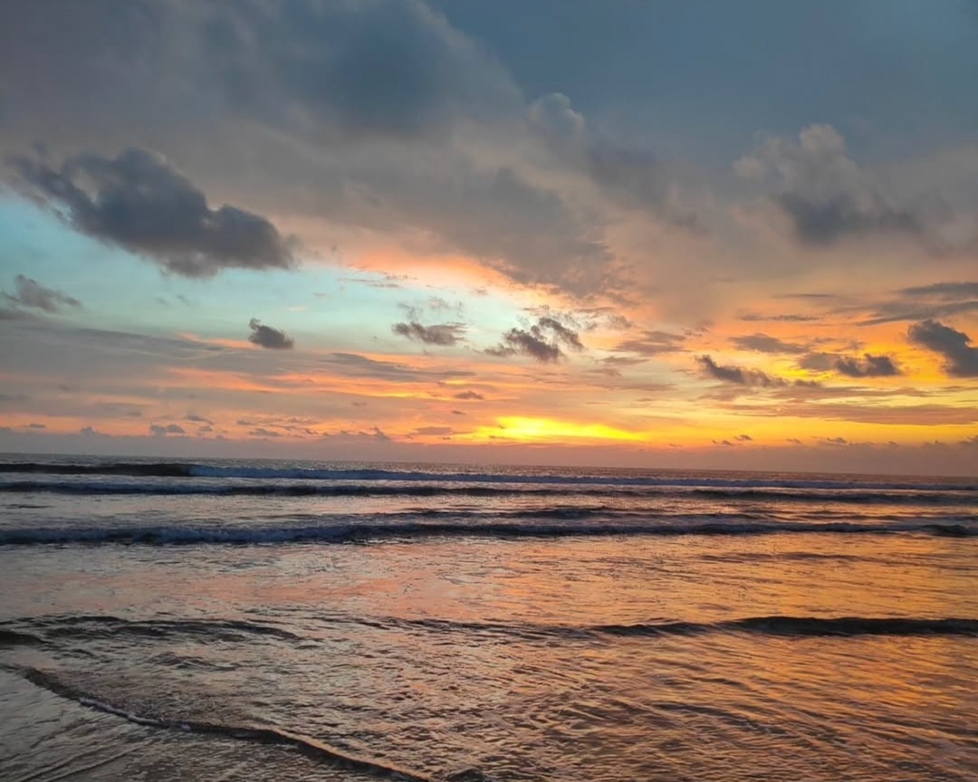 Sunset at Eco Beach, Honnavar with golden light reflecting on the clean sands and calm sea.